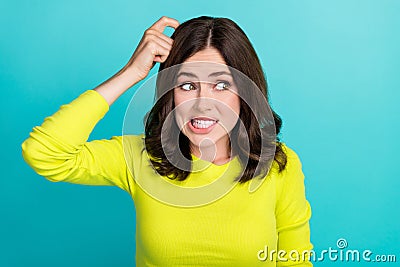 Closeup photo of young funny cute girl wear lime shirt scratch head oops sorry mistake look empty space isolated on cyan Stock Photo