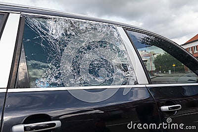 Closeup picture of black stolen damage car broken glass windows Stock Photo