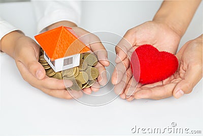 Closeup picture of female hands holding model house and red heart. charity, real estate and family home concept Stock Photo