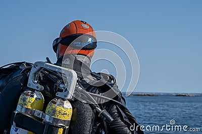 A closeup picture of a scuba diver waiting for the dive boat to get into position so he can enter the water. Ocean and Editorial Stock Photo