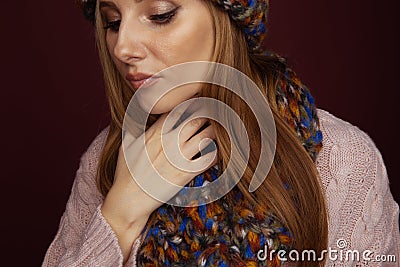 Closeup picture of woman in winter clothes holding her throat and feeling pain in it. Stock Photo