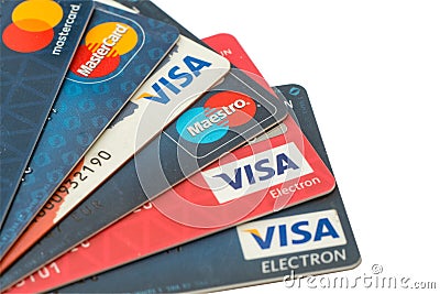 Closeup pile of credit cards, Visa and MasterCard, credit, debit and electronic. Isolated on white background with clipping path. Editorial Stock Photo