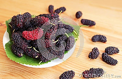 Pile of Fresh Ripe Mulberry Fruits on Wooden Background Stock Photo