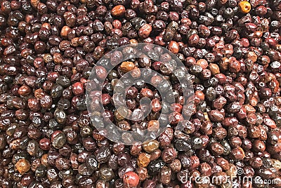 Closeup of a pile of shiny brown olives in a market Stock Photo