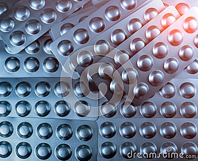 Closeup pile of tablets pills in silver blister pack. Pharmaceutical industry concept. Global healthcare. Health budgets. Stock Photo