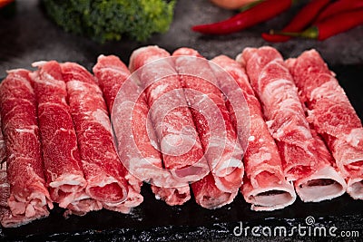 Closeup of a pile of thinly sliced rolled raw meat for hot pot Stock Photo