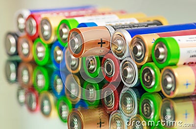 Closeup of pile of used alkaline batteries. Close up colorful rows of selection of AA batteries energy abstract background of Stock Photo