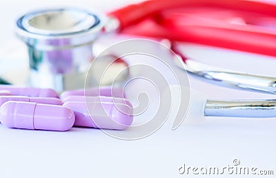 Closeup pills, capsule and stethoscope on white background Stock Photo