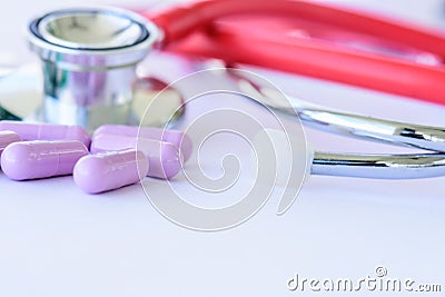 Closeup pills, capsule and stethoscope on white background Stock Photo