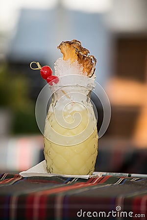 pinacolada cocktail on a shaped pineapple glass in the retaurant terrace Stock Photo