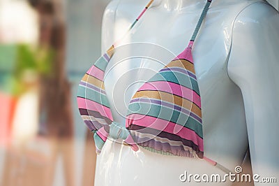 Pink tripped bikini on mannequin in fashion store showroom for women Stock Photo