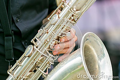 A closeup plane of saxophone in hands of sax player Stock Photo