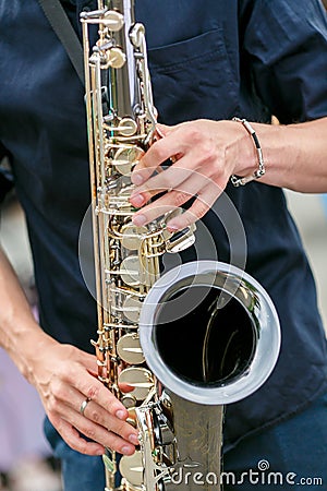 A closeup plane of saxophone player in black shirt Stock Photo