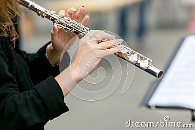 A closeup plane of street orchestra flute player Stock Photo