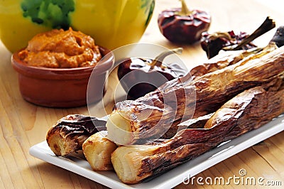 Barbecued calcots, catalan sweet onions, and romesco sauce Stock Photo