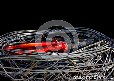 Closeup of pliers in the middle of a bunch of wires on a black background Stock Photo