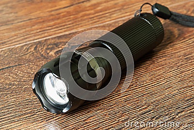 Closeup pocket LED flashlight on dark background Stock Photo