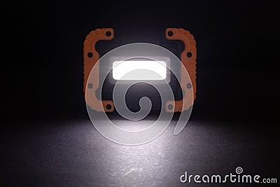 Closeup pocket LED flashlight on dark background Stock Photo