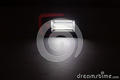 Closeup pocket LED flashlight on dark background Stock Photo