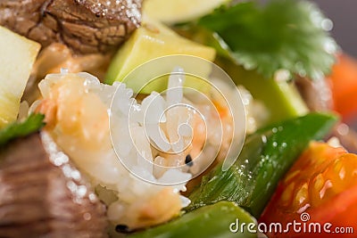 Closeup poke with beef and rice and vegetables. Hawaiian cuisine. Stock Photo