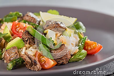 Closeup poke with beef and rice and vegetables. Hawaiian cuisine. Stock Photo