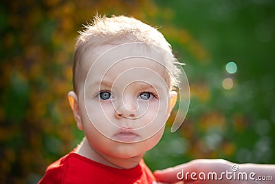 Closeup portrait of baby boy with big eyes. Serious little boy with intent look. face of small child Stock Photo