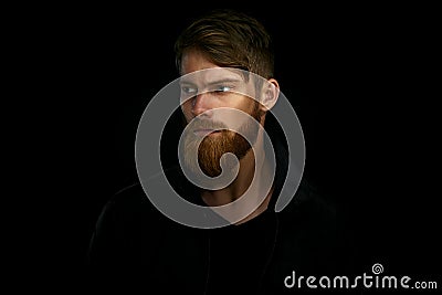 Closeup portrait of bearded handsome man in a pensive mood looking away Stock Photo