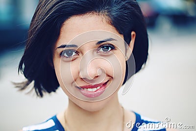 Closeup portrait of beautiful smiling young latin hispanic girl woman with short dark black hair bob Stock Photo