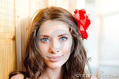 Closeup portrait of beautiful young blue eyes lady with shadow from window blinds on light copy space background Stock Photo