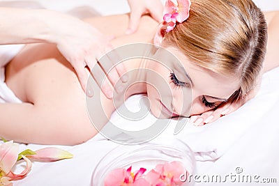 Closeup portrait on beautiful young woman having spa treatments: enjoying massage, stones & aroma therapy Stock Photo