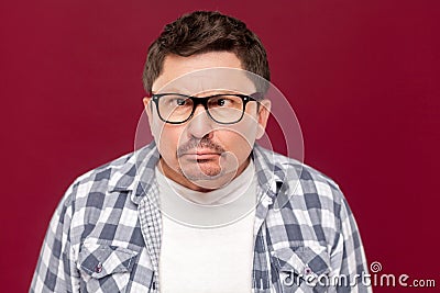 Closeup portrait of crazy funny middle aged business man in casual checkered shirt, eyeglasses and mustache standing with crossed Stock Photo