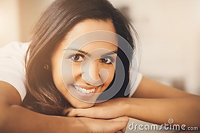 Closeup portrait of cute Indian teenage girl smiling at home Stock Photo