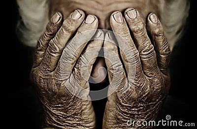 Closeup portrait depressed old woman covering her face with hand Stock Photo