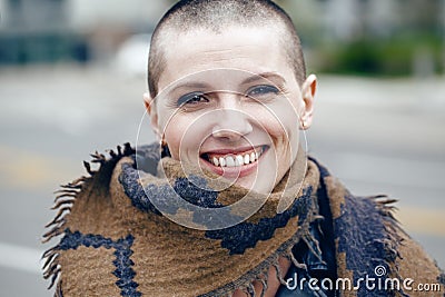 Closeup portrait of happy smiling laughing beautiful Caucasian white young bald girl woman with shaved hair head Stock Photo