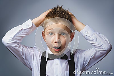 Closeup portrait headshot nervous anxious stressed afraid boy isolated grey background. Negative emotion facial Stock Photo