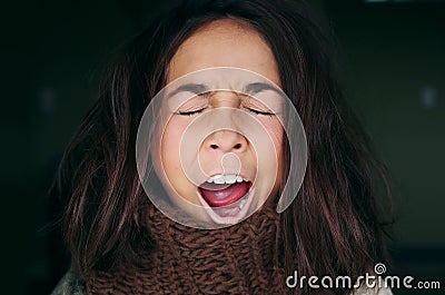 Closeup portrait headshot sleepy young woman with wide open mouth yawning eyes closed looking bored, in black background Stock Photo