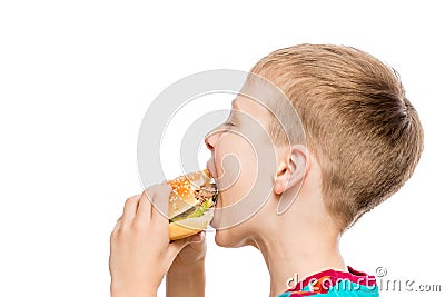 Closeup portrait of a hungry boy with a hamburger on white background Stock Photo