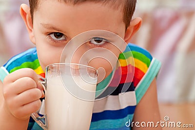 Closeup portrait of a little boy drinking milk Stock Photo