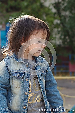 closeup portrait of little cute emotional girl with pigtails in a denim jacket Stock Photo