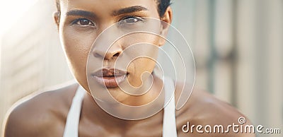 Closeup portrait of one fit young hispanic woman taking a rest break to catch her breath after a run or jog in an urban Stock Photo