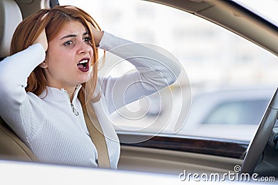 Closeup portrait of pissed off displeased angry aggressive woman driving a car shouting at someone. Negative human expression Stock Photo