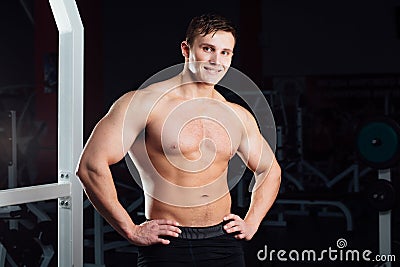 Closeup portrait of professional bodybuilder workout with barbell at gym. Confident muscular man training . Looking Stock Photo