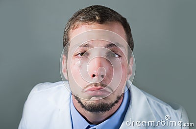 Closeup portrait of sad young doctor crying Stock Photo