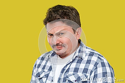 Closeup portrait of serious handsome middle aged business man in casual checkered shirt standing and looking at camera with Stock Photo