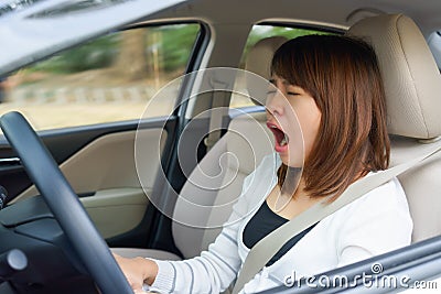 Closeup portrait sleepy, yawn, close eyes young woman driving he Stock Photo