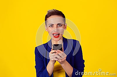 Closeup portrait surprised screaming young girl looking you camera phone in hands seeing news or photos with funny emotion on her Stock Photo