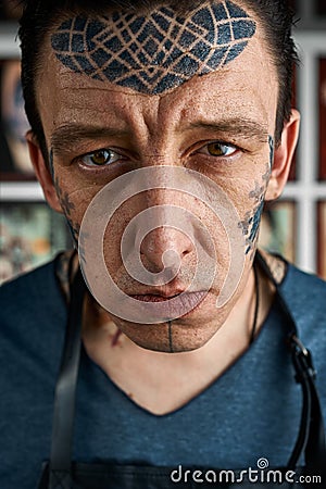 Closeup portrait of tattooist in studio Stock Photo