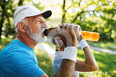 Closeup portrait, thirsty senior man drinking water outside Stock Photo