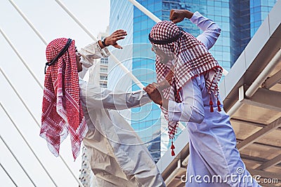 Closeup portrait of two Arab guys fighting, Aggressive behavior, on city background Stock Photo