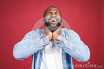 Closeup portrait upset stressed young african american man squeezing his head, going nuts, screaming, losing his mind, isolated Stock Photo